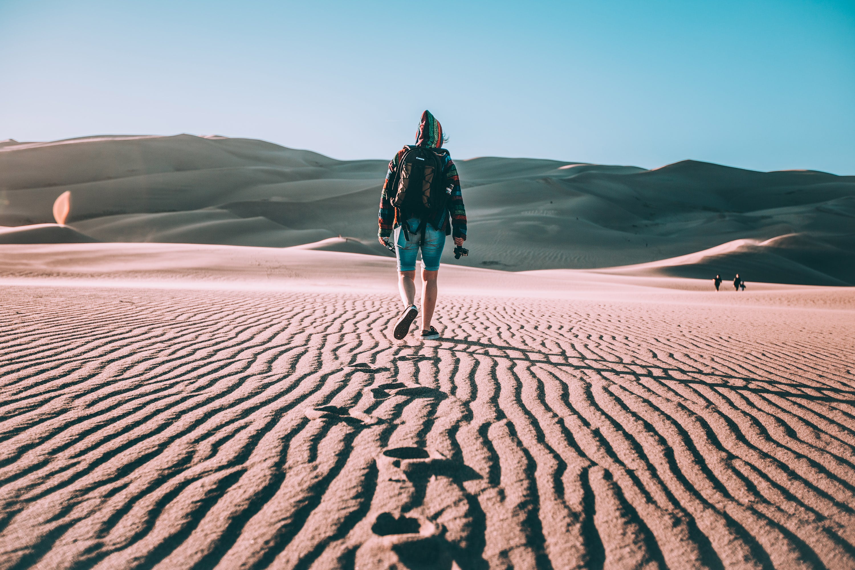 Photographer walking in the desert
