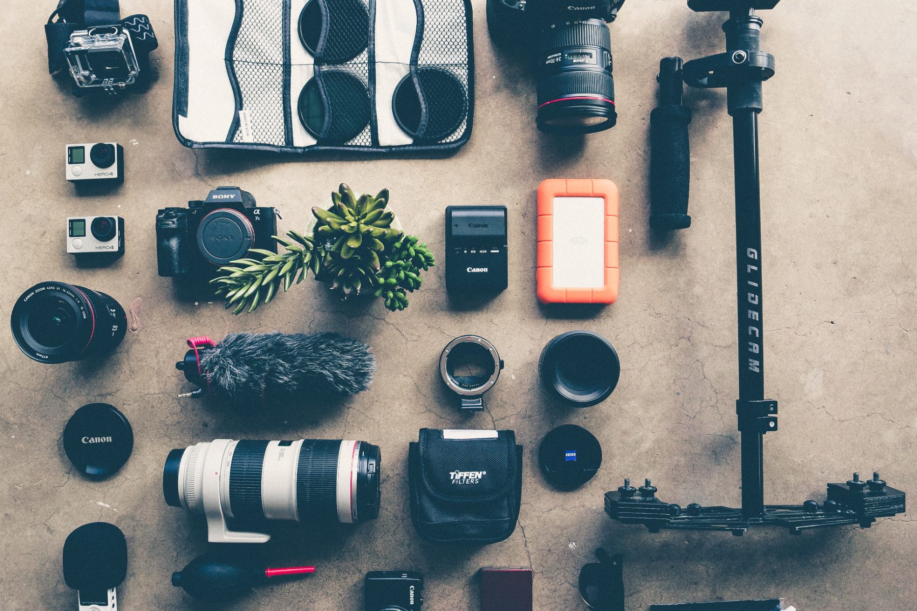 Cameras, lenses and audio equipment arranged on a floor